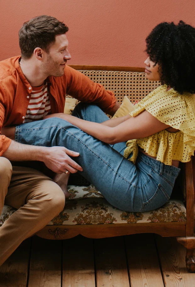 A man and woman share a moment on the couch