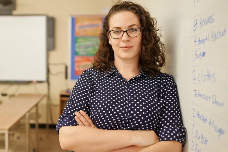 Woman wearing glasses standing in an office