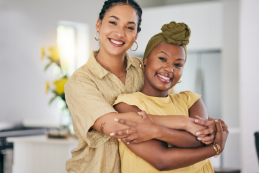 Two women embracing and smiling