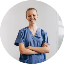 A fertility nurse smiles with a stethoscope over her shoulders